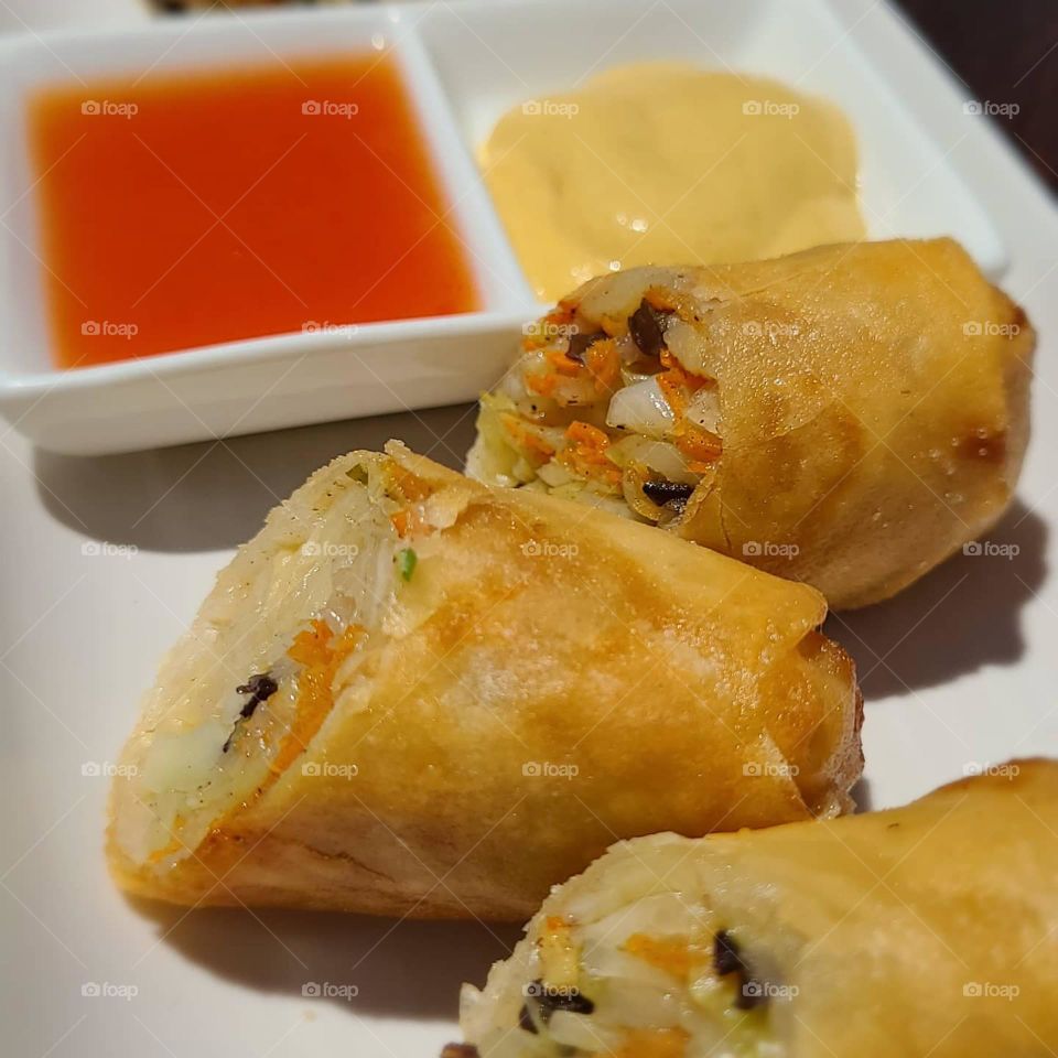 Crispy vegetable egg rolls with hot Chinese mustard and sweet sauce. Crispy, succulent satisfying  appetizers 