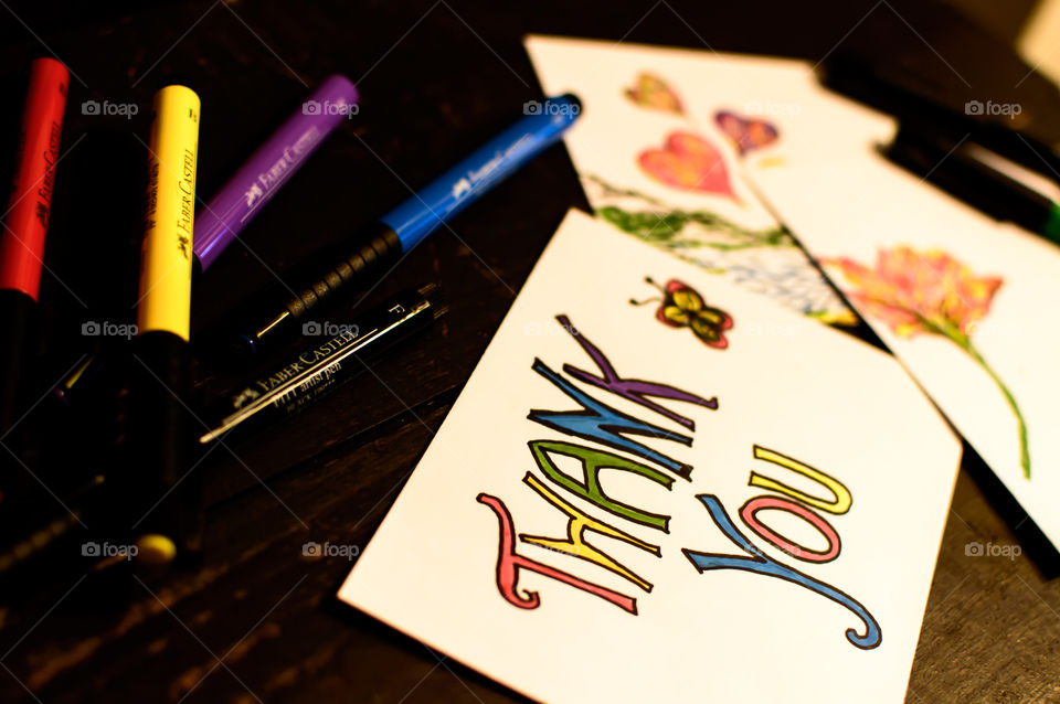 Making home made thank you and gratitude cards with Faber-Castell PITT artist pen wishing for spring with colorful pens on rustic wood conceptual background photography 