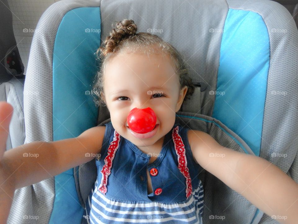 Portrait of child girl with clown nose