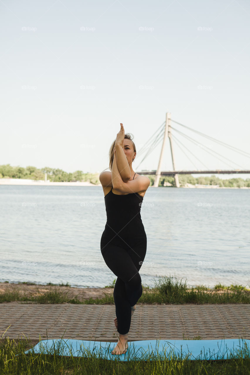 young woman doing yoga in the park