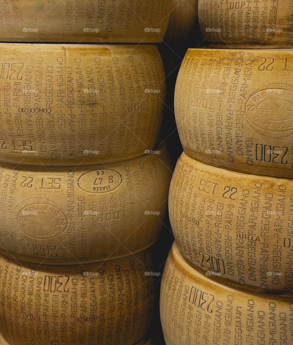 large wheels of parmesan cheese, parmigiano reggiano, made in Italy, Parma
