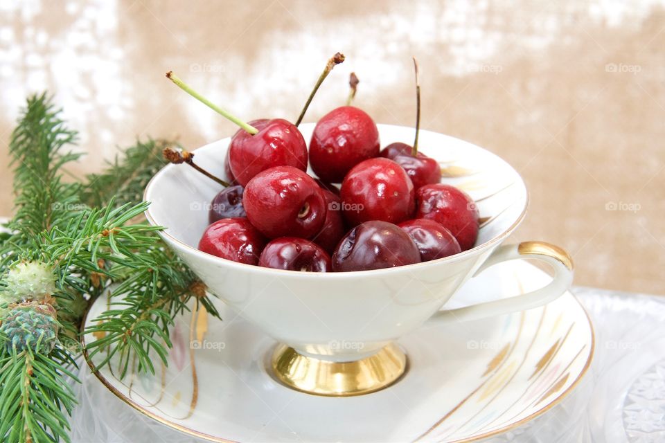 cherries in teacup