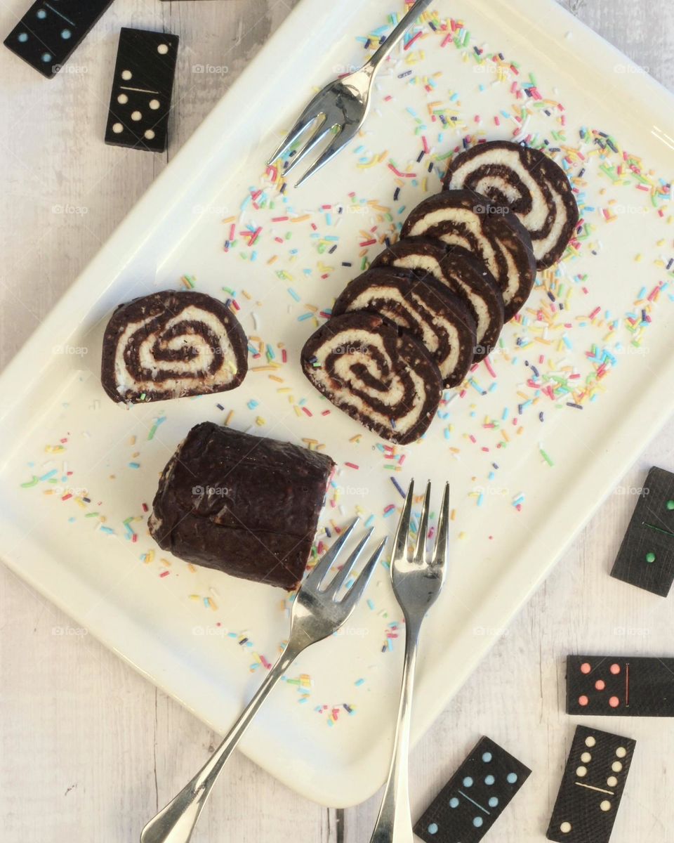 Sweet rolls of chocolate and cocos on all white background.
