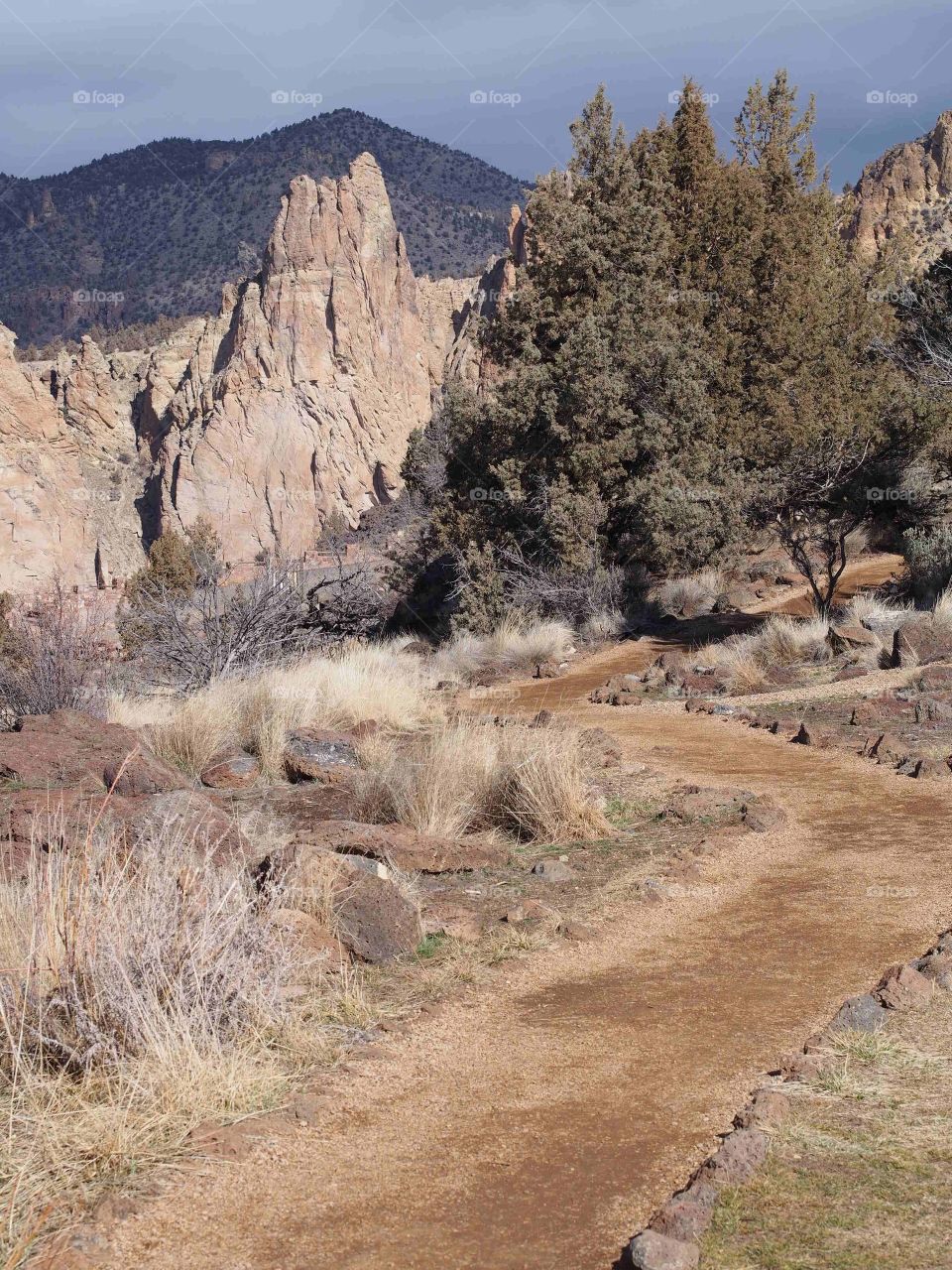A nice dirt trail bordered with rocks goes through Smith Rock State Park in Central Oregon. 