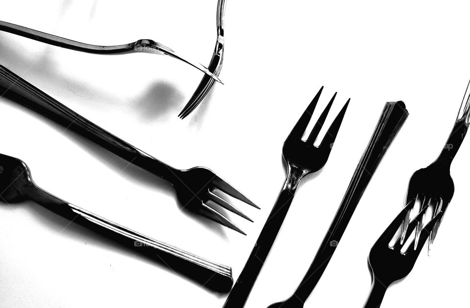 Appetizer forks in black and white.