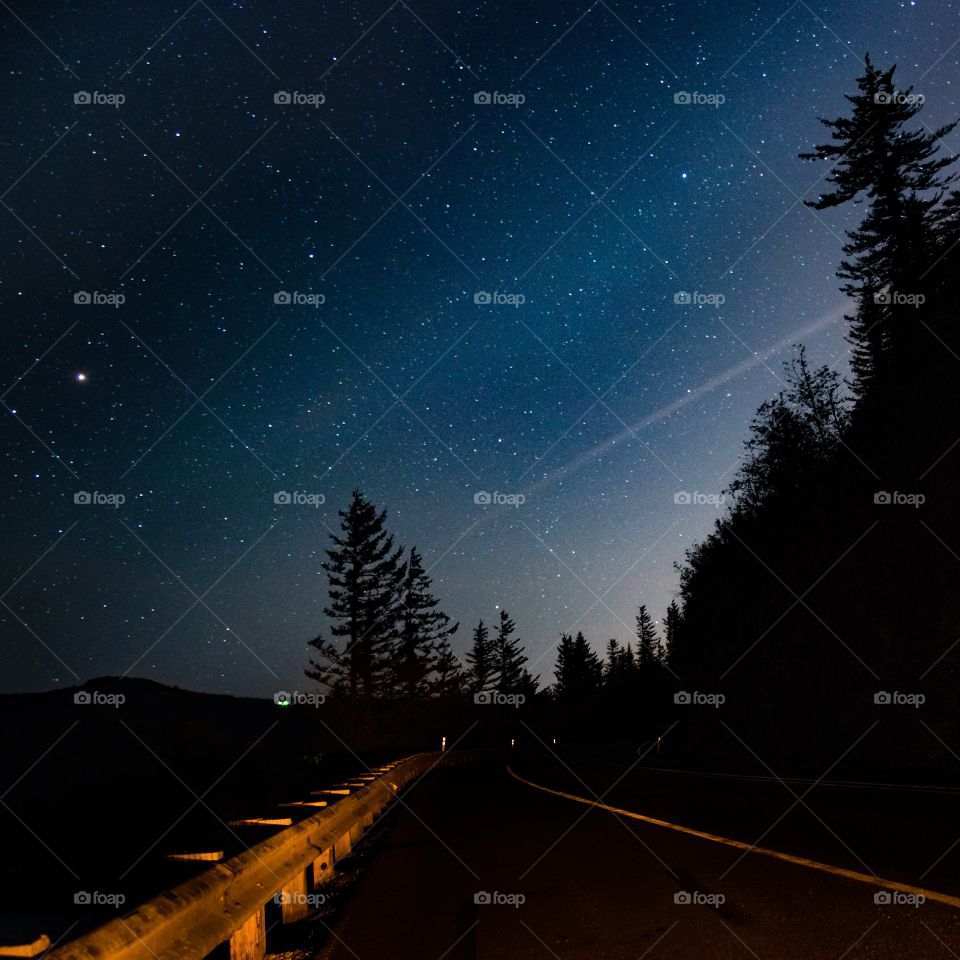 Empty road against starry sky