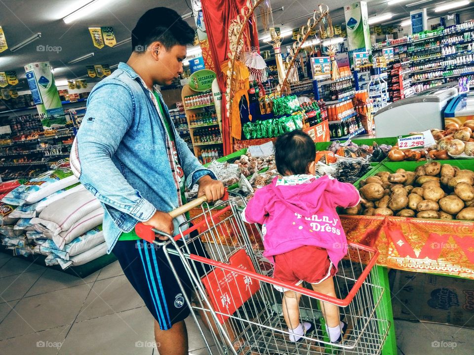 Father with his son in supermarket