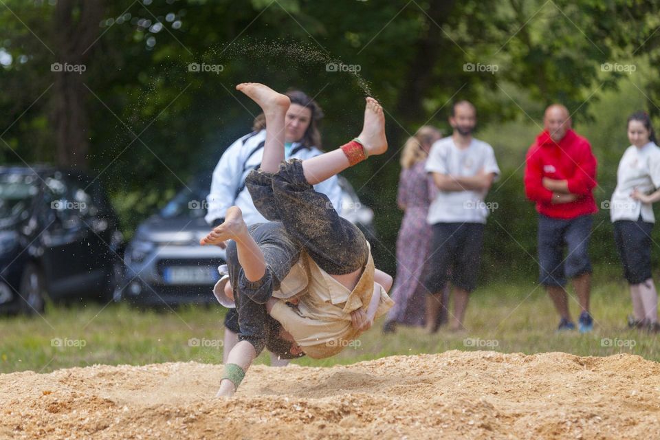 Two gouren practitioners wrestling on sawdust