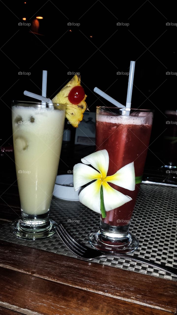 Cocktails in Thailand. Two cocktails with straws and a flower