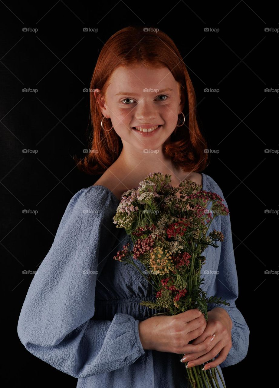 Young woman,holding flowers into her hands ,red hair and only twelve years old . 💛 💙💜