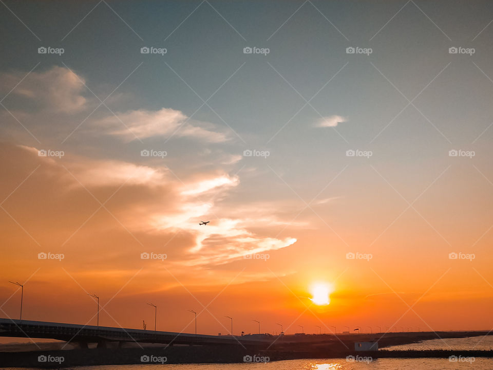 Plane and Sunset at Pantai Indah Kapuk (PIK) Jakarta, Indonesia