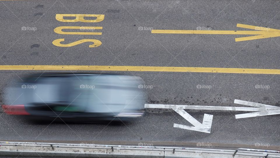 Car driving next to buslane