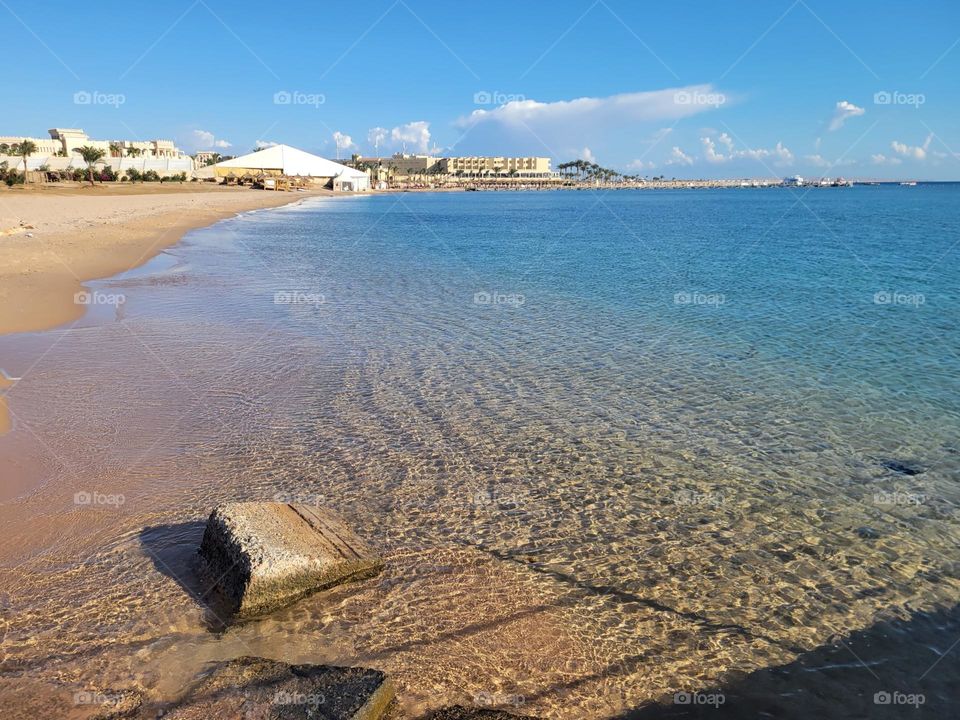 cloudless sunny day - beach going to the pier to get onto the boat for diving and snorkeling at Hurghada Egypt