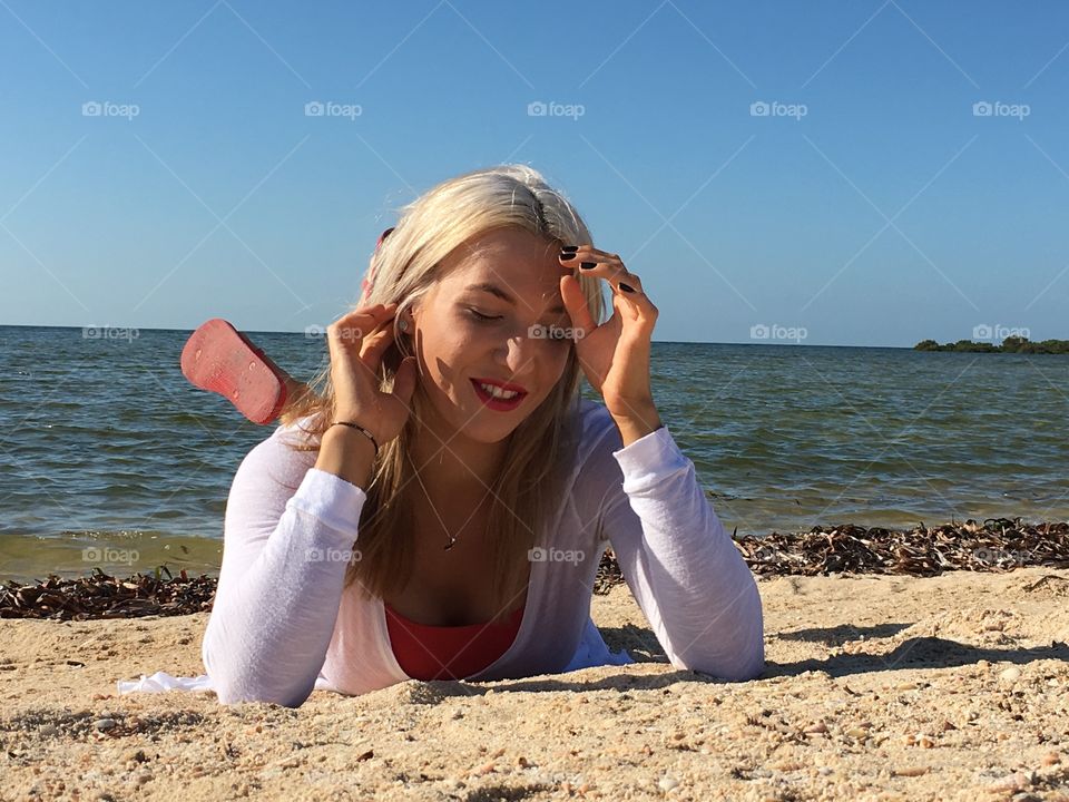 Woman lying on sand at beach