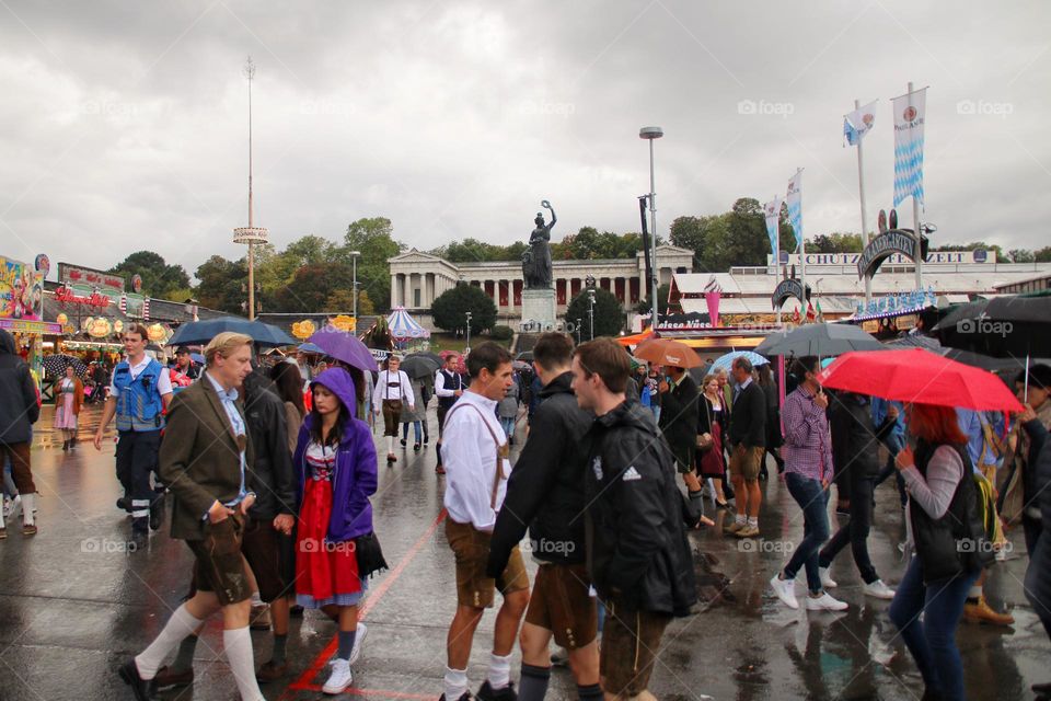 People walk in the rain at the Oktoberfest