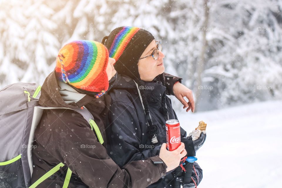 Friends hiking in the mountain and drinking Coca-Cola 