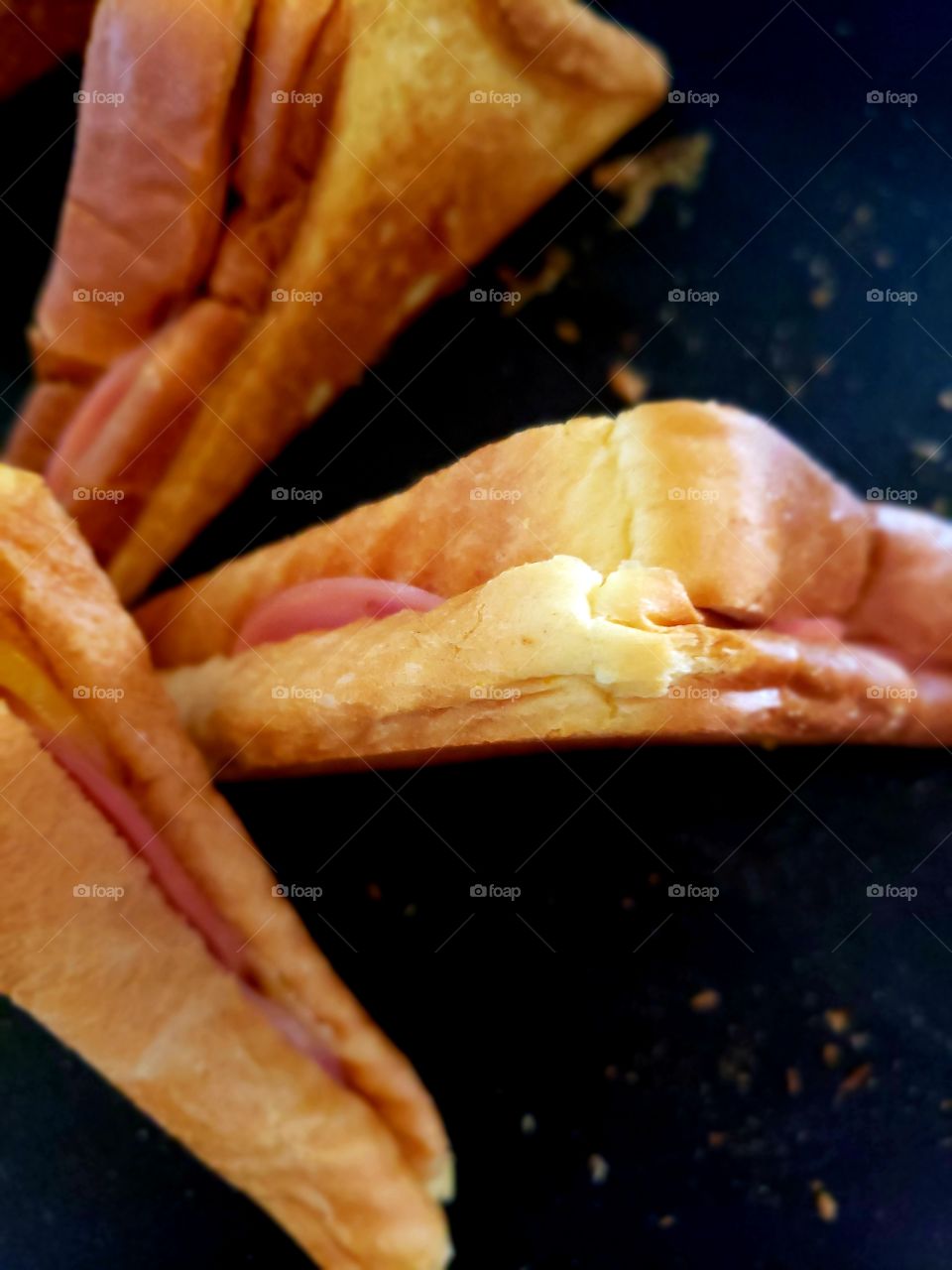 Closeup texture of a hot delicious toasted ham and cheese sandwich