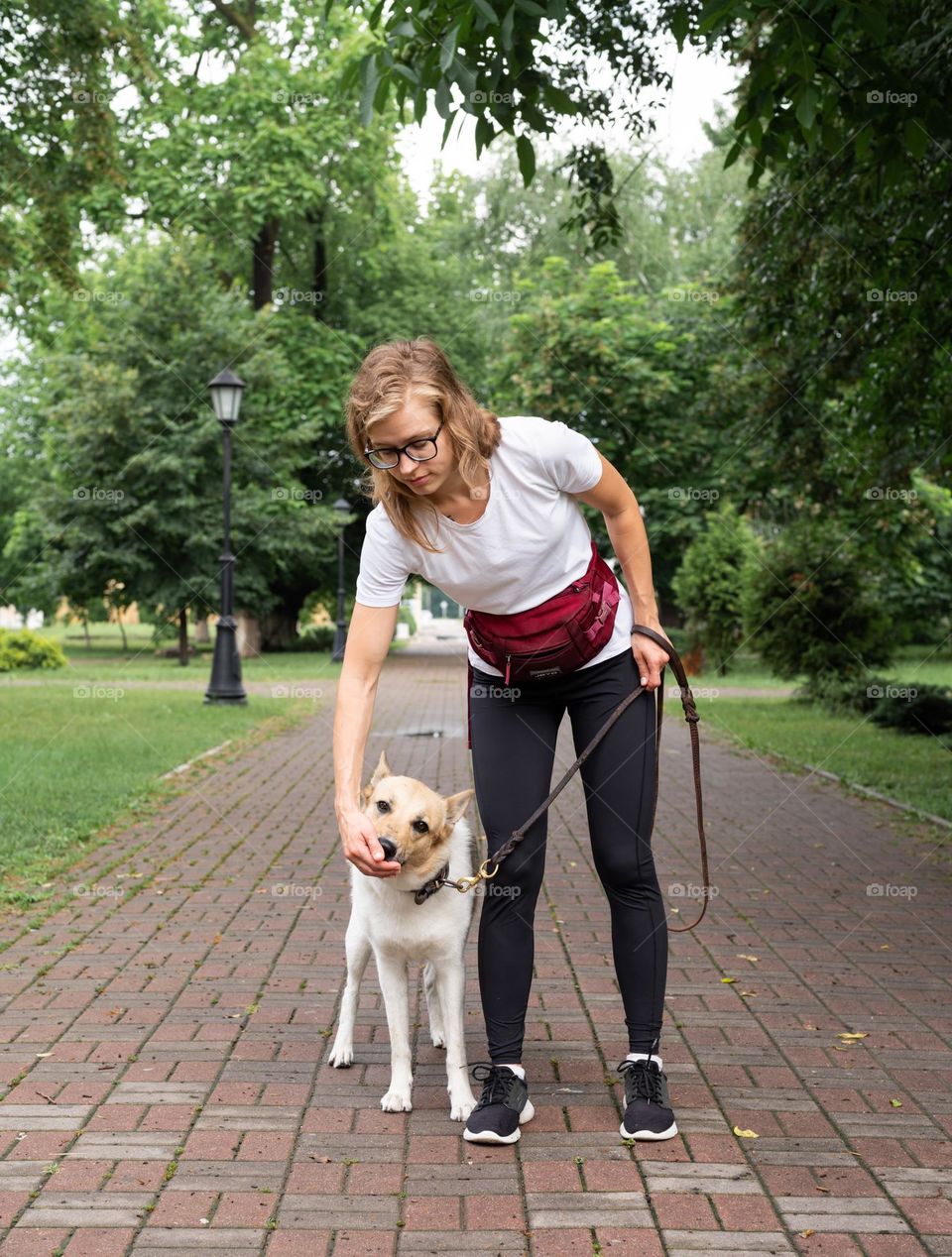 woman walking the dog in rainy day