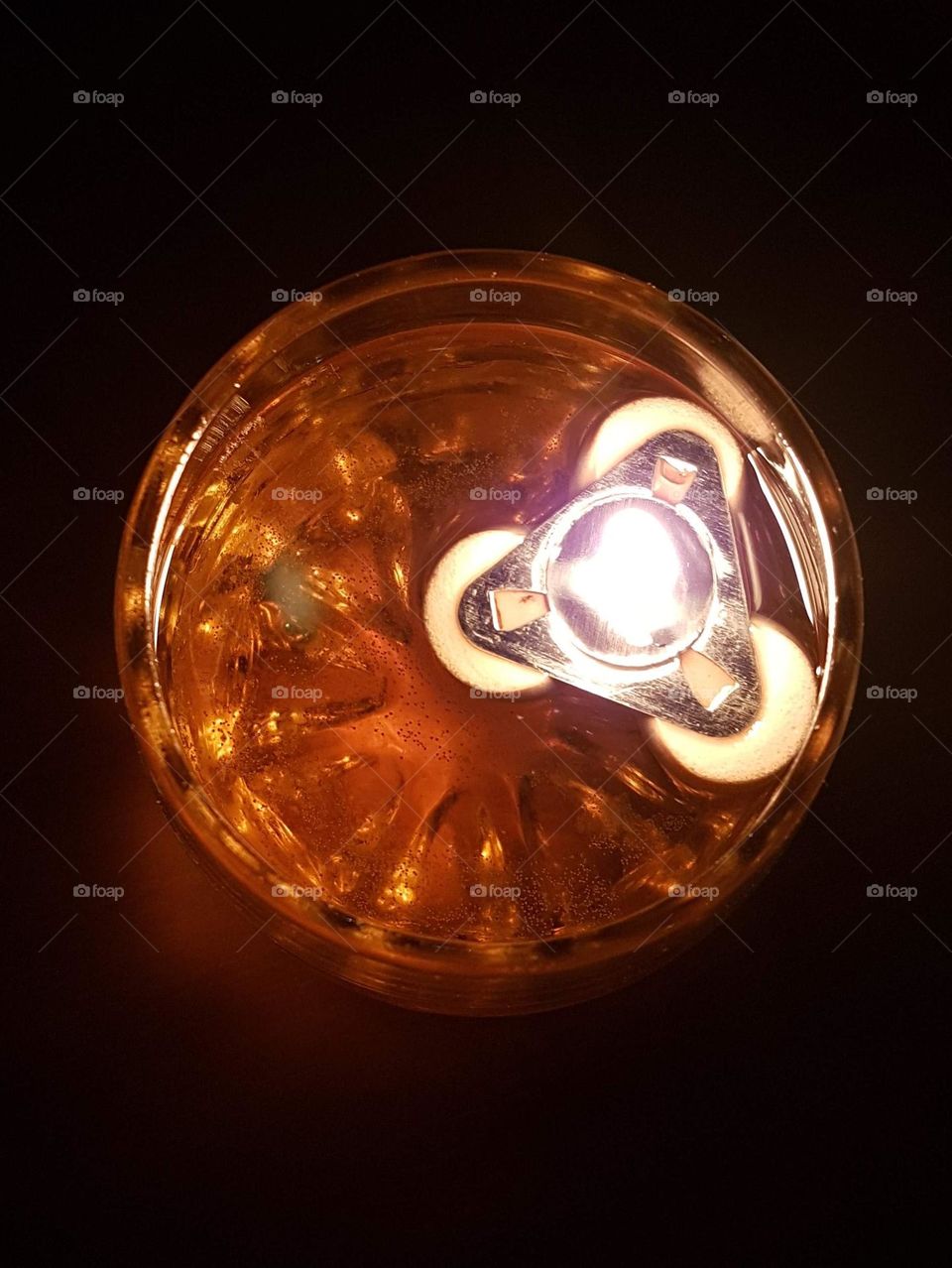 A candle in the water glass