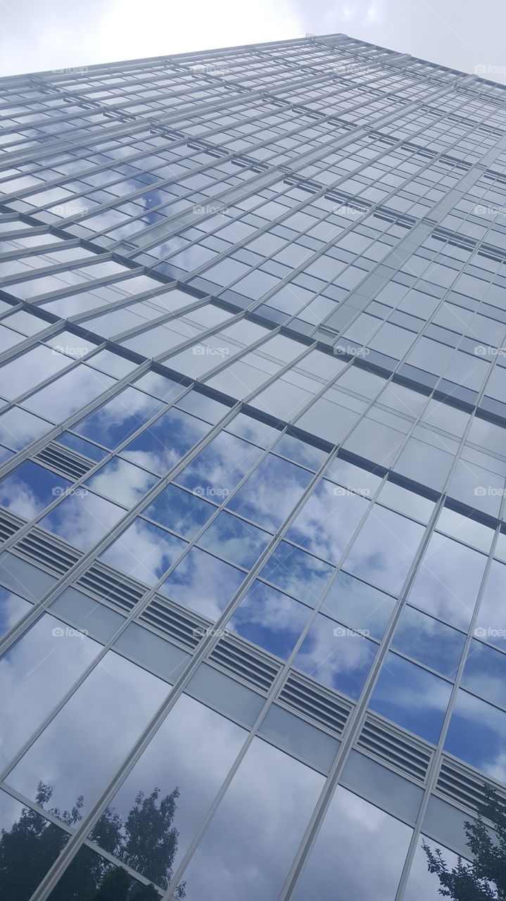 skyscraper reflecting blue sky and clouds