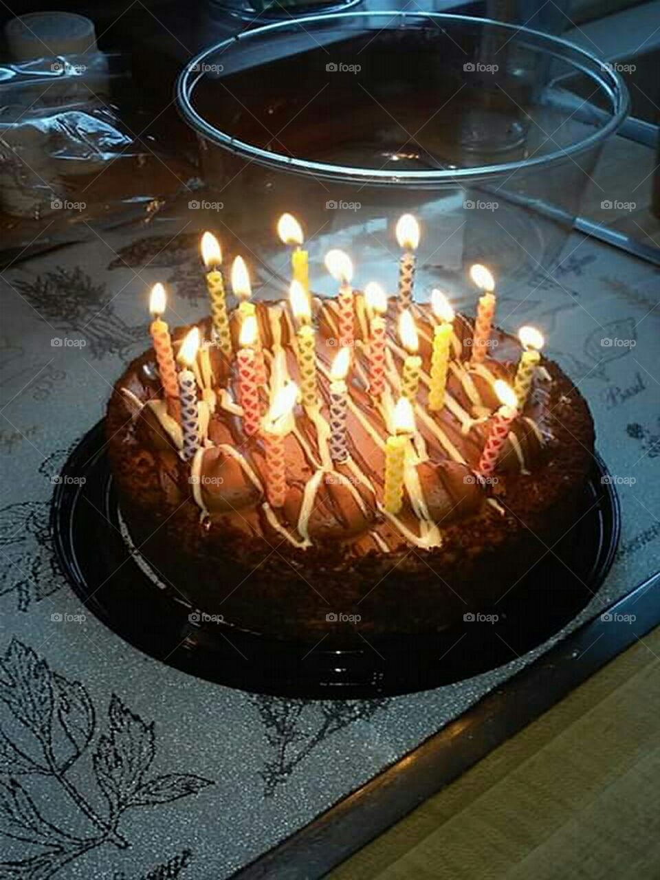delicious looking chocolate birthday cake with birthday candles lit