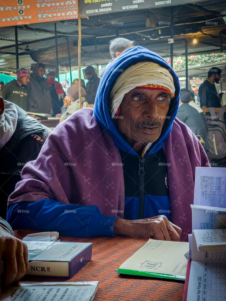 Old man from village wearing different sort of clothes to protect him from winter