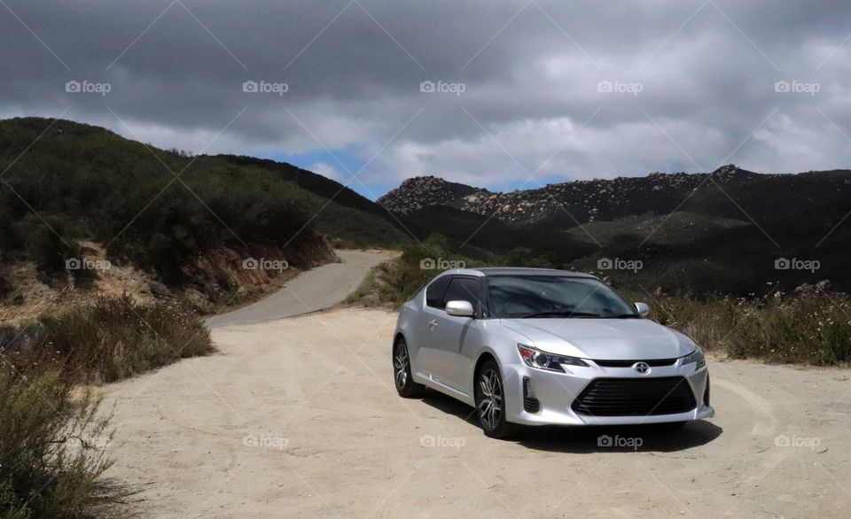 scion tc resting by the mountain road