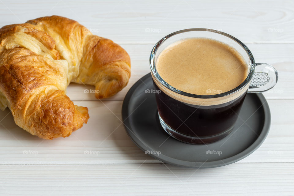 croissant and black coffee