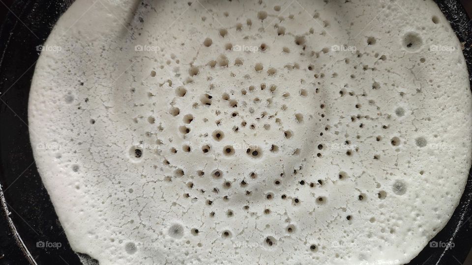 Rice batter getting circular patterns after getting heated up in a dosa tawa