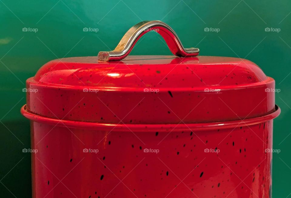 Red cookie jar with green background