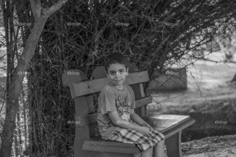 Boy sitting on bench