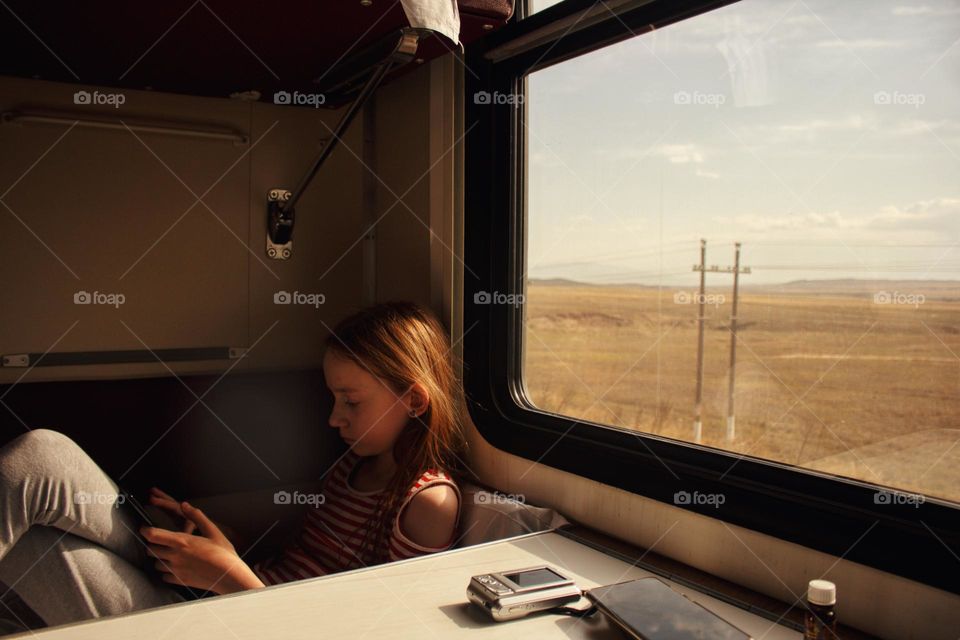 Girl near the window in the train 