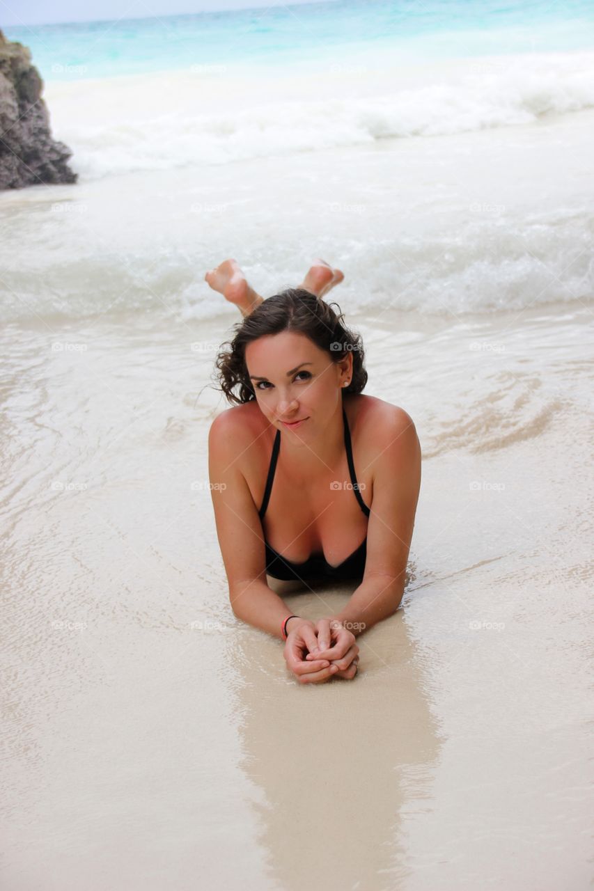 Pretty woman lying in sea