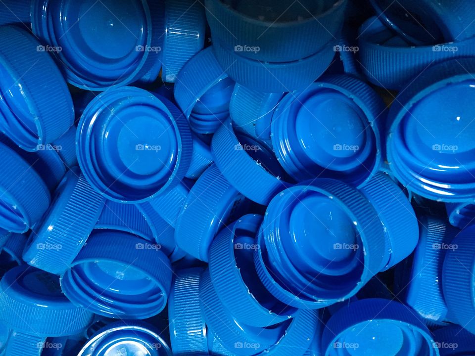The blue color bottle cups background. Recycling materials. 
