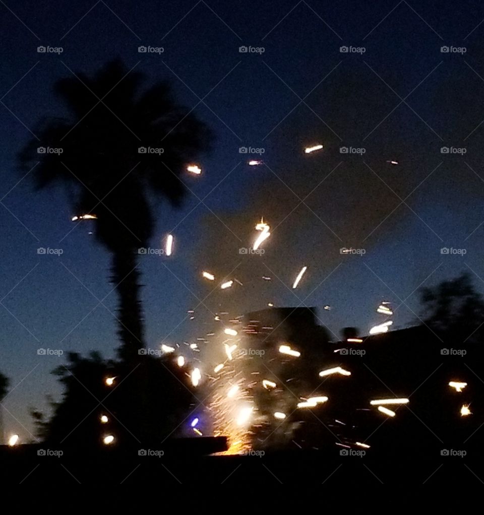 Sparklers light up silhouette of neighborhood