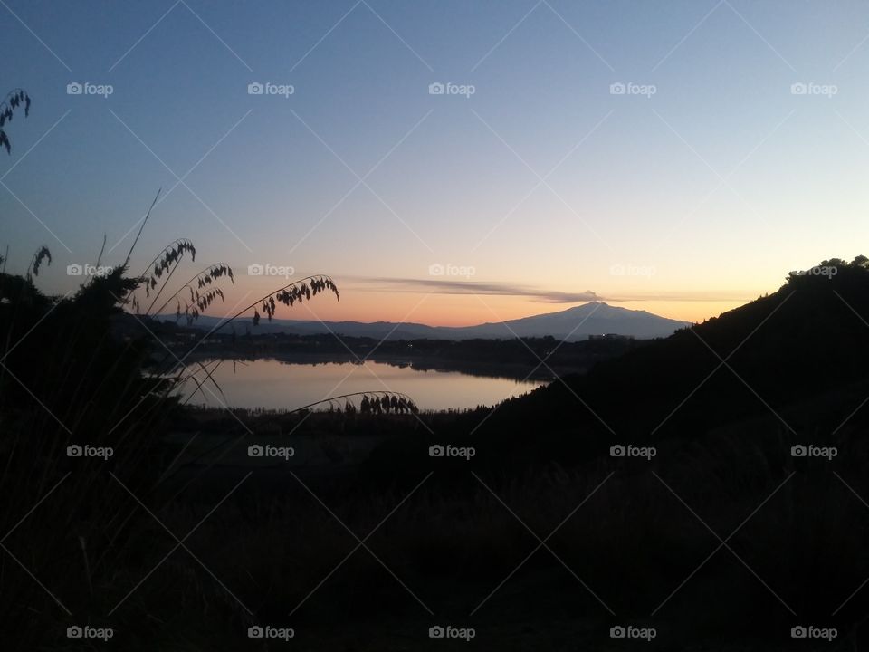 Volcano Etna sunrise with lake