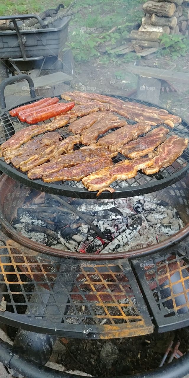 The Meats over a fire pit