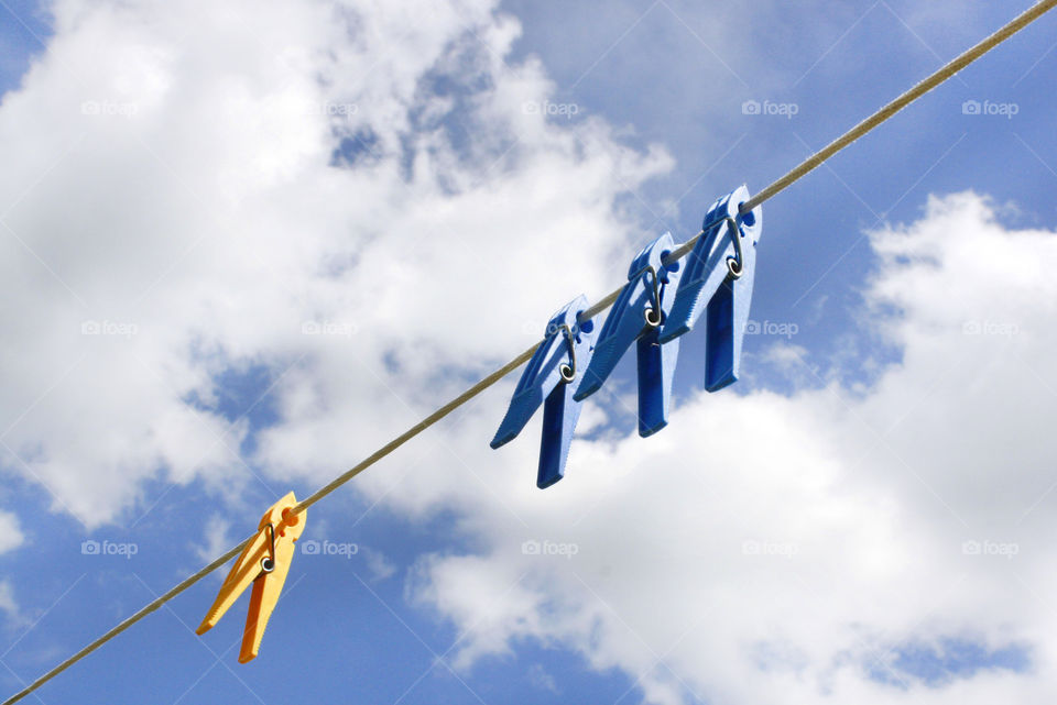 Colorful clothespins and clouds