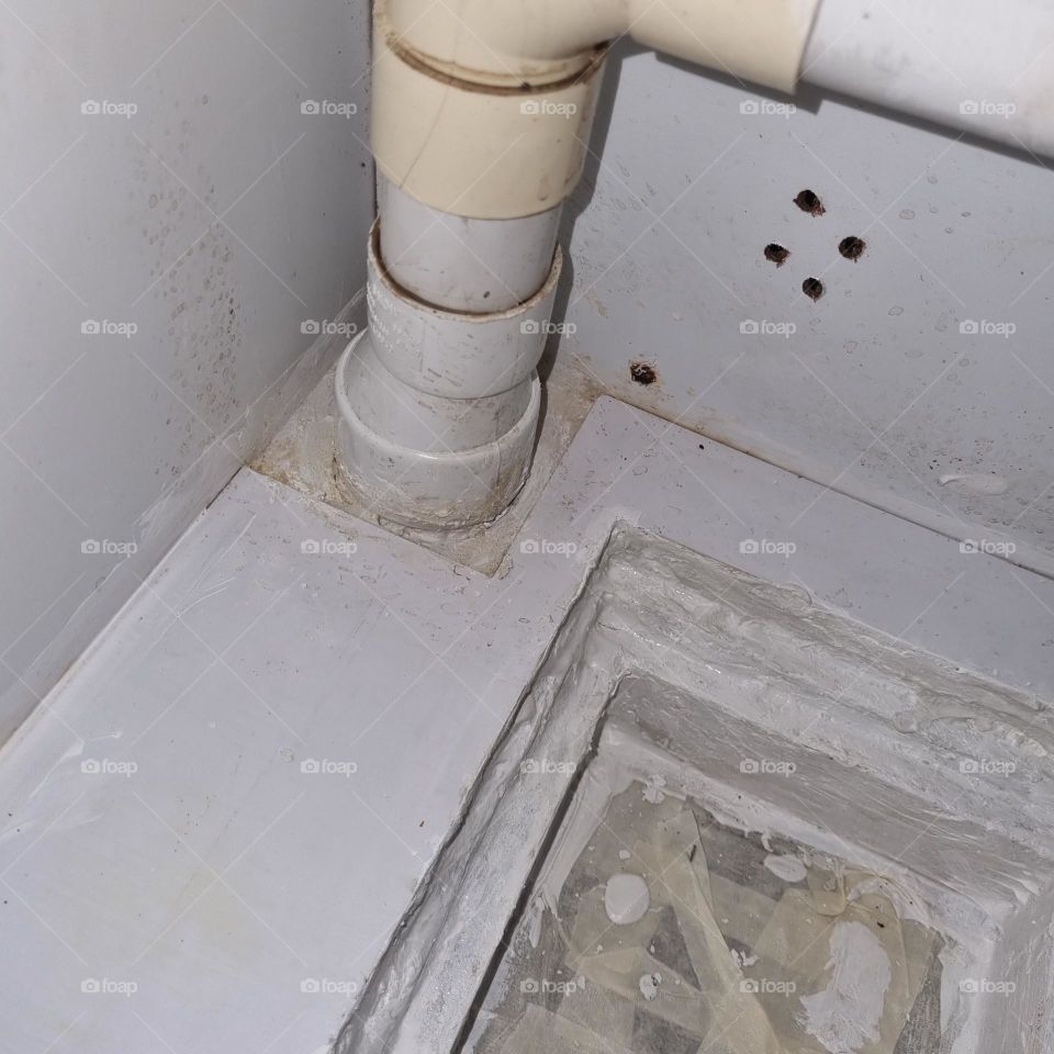 Patched up the floor trap with white cement