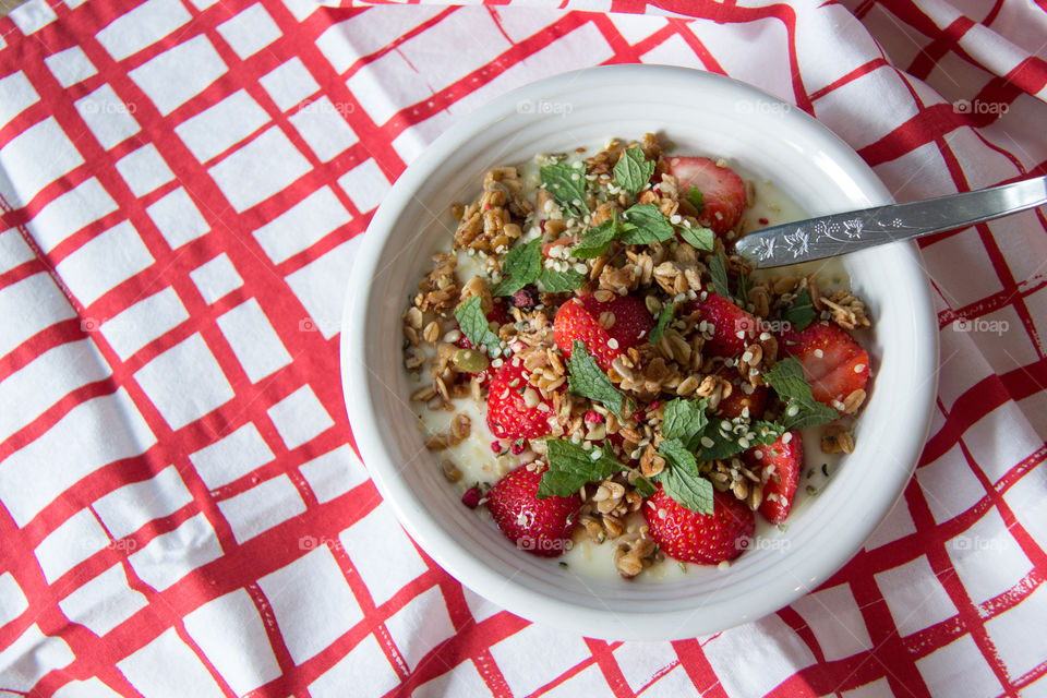 Yoghurt with granola and strawberries and hempseed 