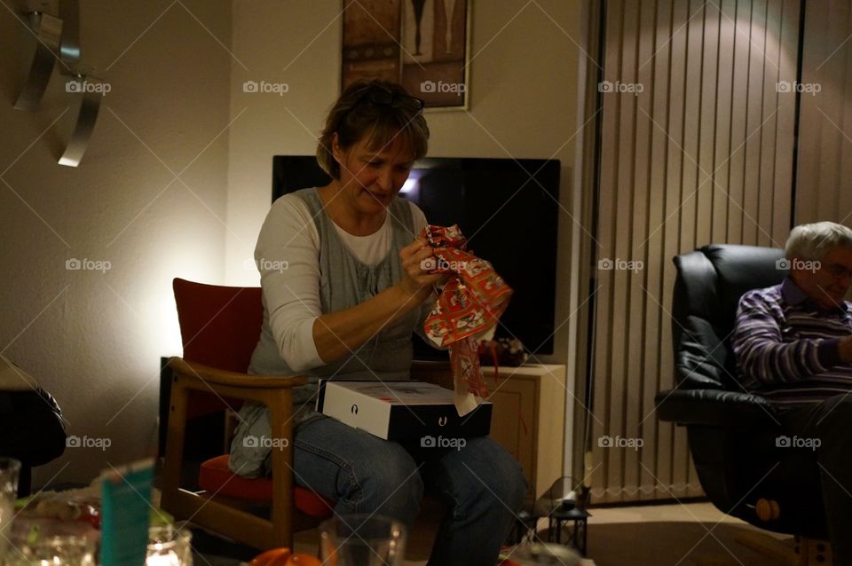 Woman unwrapping gift