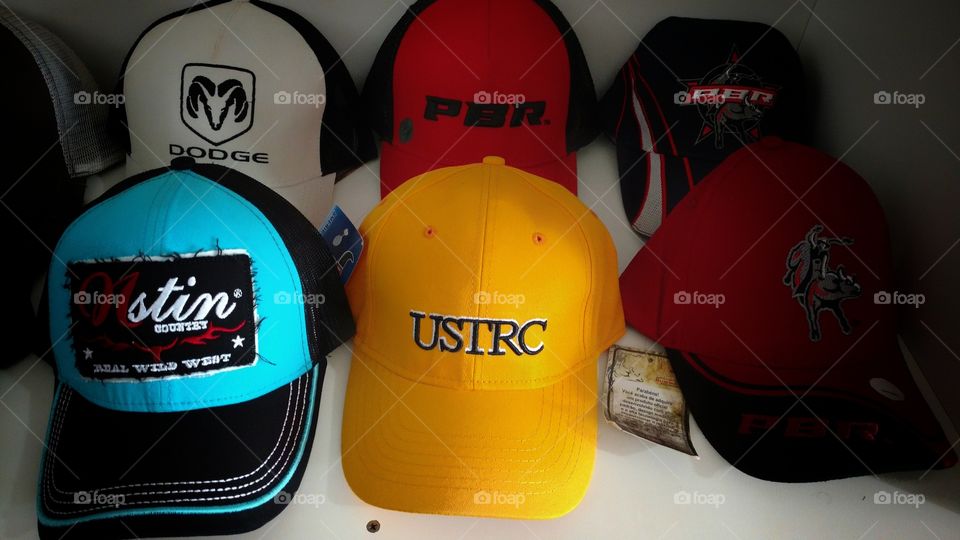 Bonés de várias marcas, coloridos, em loja de vestuários.