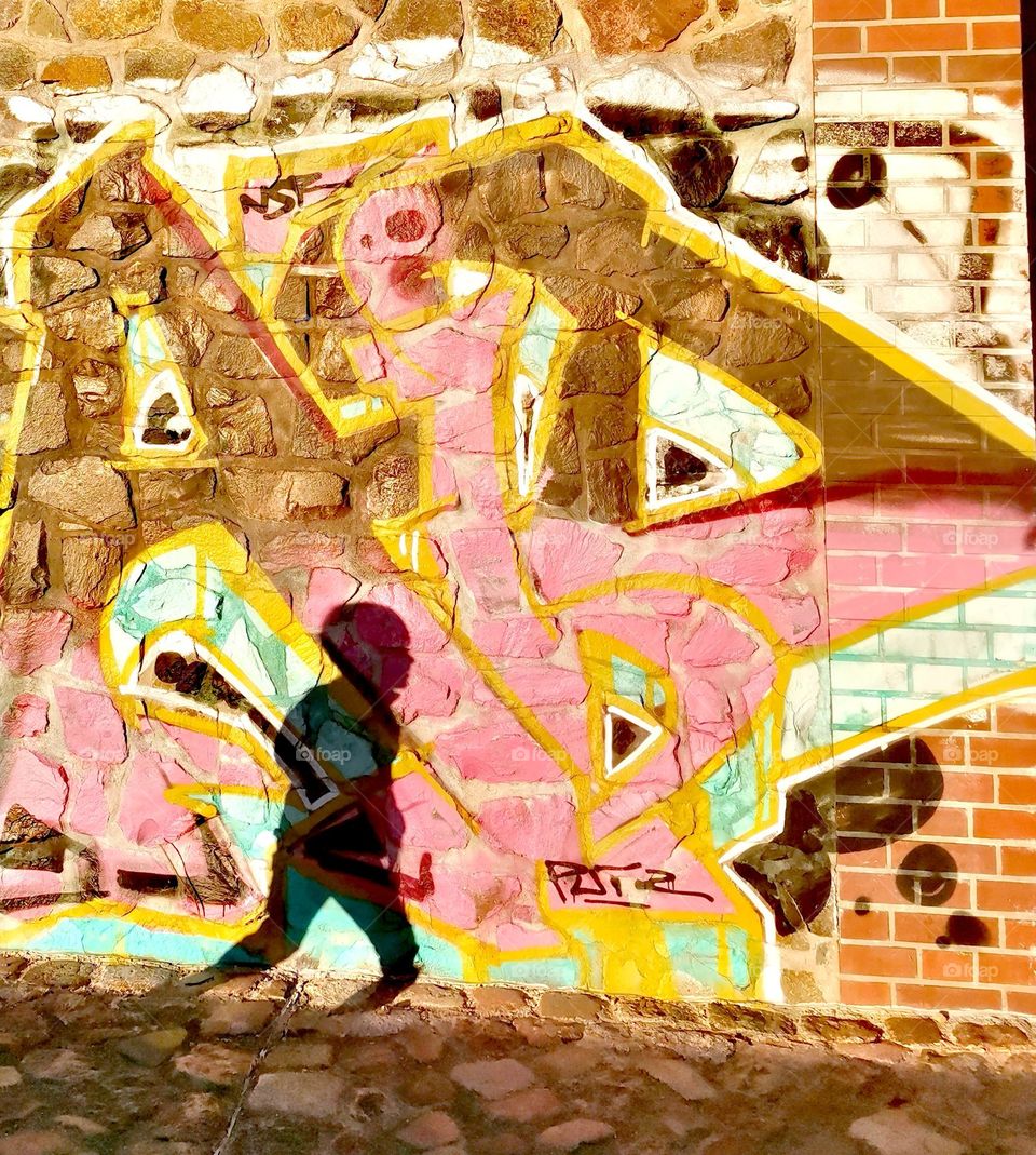 Graffiti with ashadow of a running child