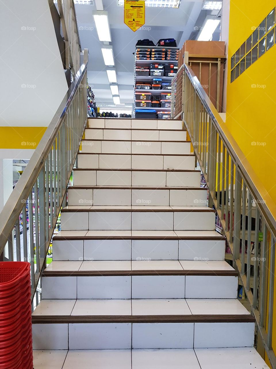 Shop stairs in a four-storey building, conventional stairs, climbing stairs on foot, limited by stair railings