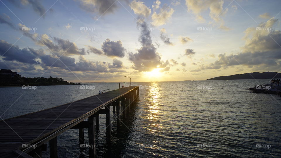Wooden bridge at Rayong beach and beautiful sunlight with cloud 