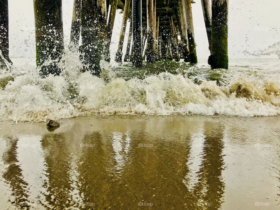 Beautiful splashes and mini waves under the wharf 