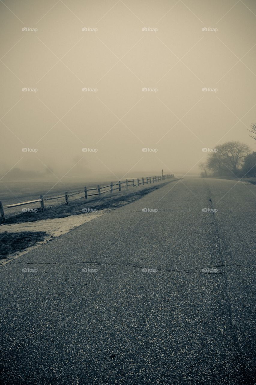 Monochrome Winding Road With Fence In Heavy Fog, Landscape Portrait In Black And White, Empty Country Road, Roads Of America, Landscape Of A Foggy Road 