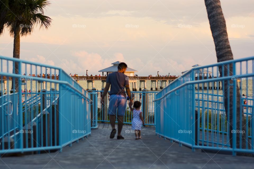 Take a walk father daughter walk by the pier