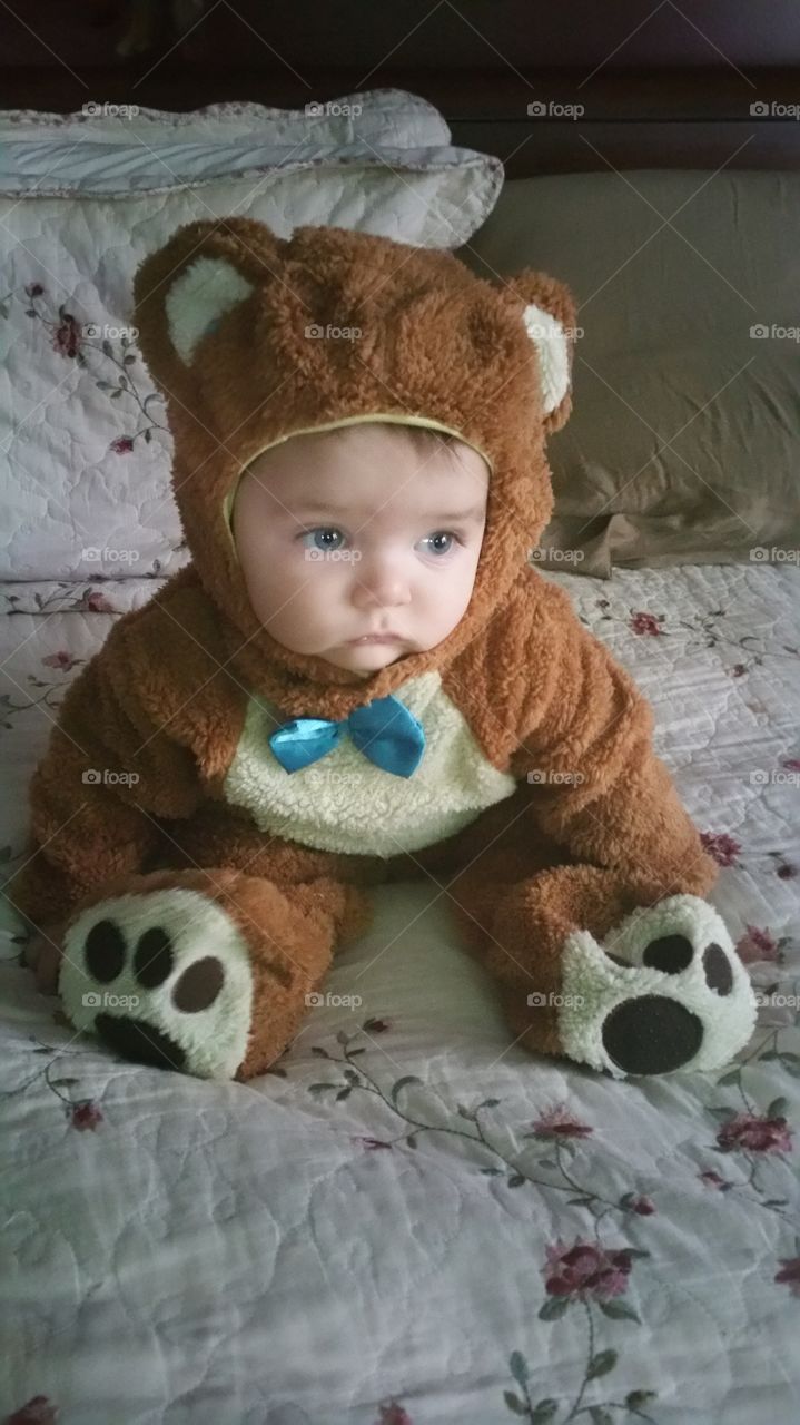 Cute baby in teddy bear costume