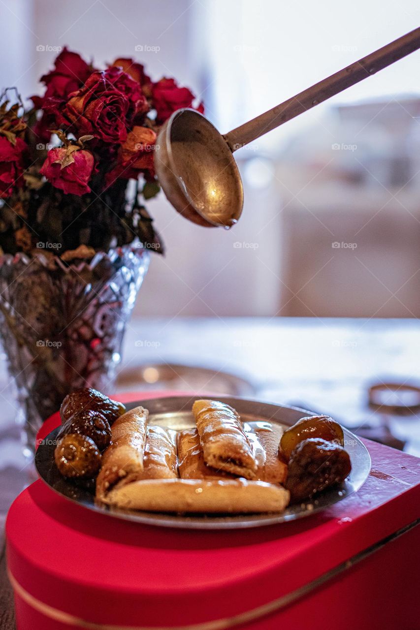 A fig cookies and fig's sweet on the heart shaped pot and the red Roses at the table